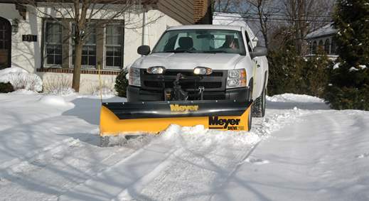 White pickup truck with Meyer Drive Pro snow plow clearing a residential driveway